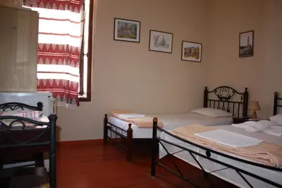 a room with two beds and a window at MmeBassia in Chania Town