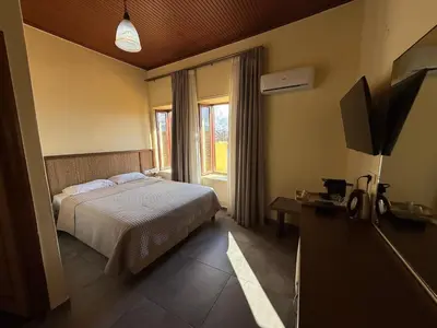 a hotel room with a bed and a window at Helena Hotel in Chania Town