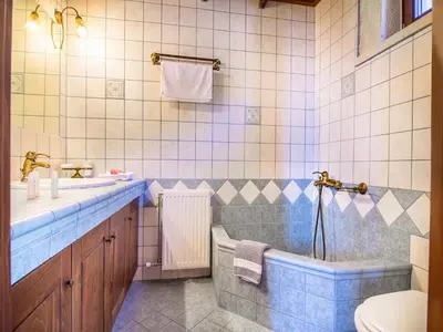 a bathroom with a tub and a sink and a toilet at Falasarna Villas in Falasarna