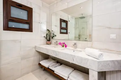 a bathroom with a sink and a mirror at Villa Arhontariki in Kissamos