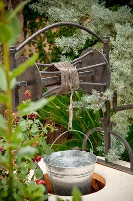 a bird bath in a garden with a plant at Villa Arhontariki in Kissamos