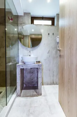 a bathroom with a sink and a mirror at Gregory Comfort Hotel in Kalamaki Chanion