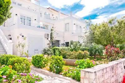 a house with a garden in front of it at Barbaras Apartments in Kato Daratso