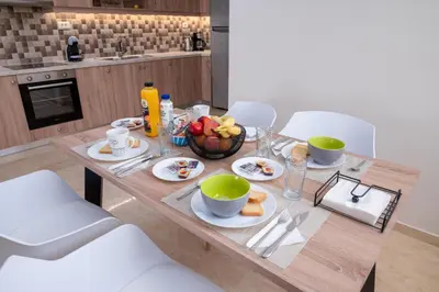 a wooden table with a bowl of fruit on it at Barbaras Apartments in Kato Daratso