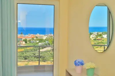 a room with a window with a view of the ocean at Aristea Apartments in Palaiochóra