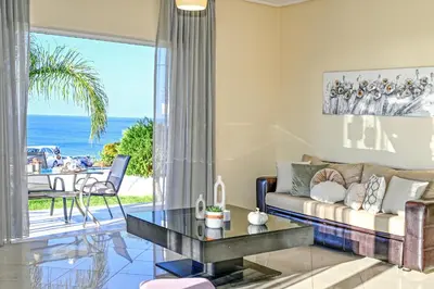 a living room with a couch and a table at Aristea Apartments in Palaiochóra