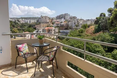 a balcony with a table and chairs and a city at Studio 71!Charming flat in Chania in Chania Town