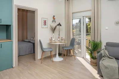 a living room with a table and chairs and a bedroom at Studio 71!Charming flat in Chania in Chania Town