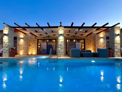 a swimming pool in a hotel at night at Villa Elena Chania in Karefilianá