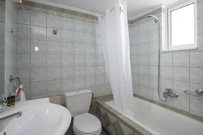 a bathroom with a toilet and a tub and a sink at Angel-kolymvari4you in Kolymvari