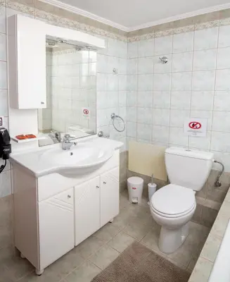 a bathroom with a white toilet and a sink at Angel-kolymvari4you in Kolymvari