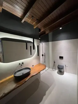 a bathroom with a sink and a toilet at Nidus Villa in Souda