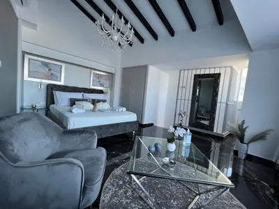 a living room with a bed and a glass table at Mare suites 1 in Chania Town