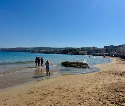 a group of people standing on the beach at Mare Suites 2 in Chania Town