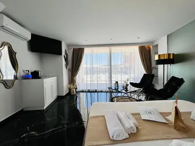 a bedroom with a bed with two towels on it at Mare Suites 2 in Chania Town