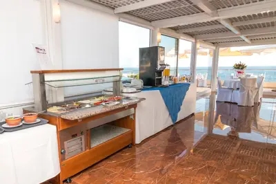 a kitchen with a grill in a restaurant at Porto Alegre Hotel in Kalamaki Chanion