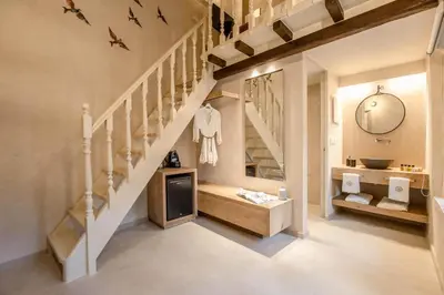 a room with a staircase with a sink and a mirror at J&G Suites in Chania Town
