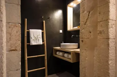 a bathroom with a sink and a towel on a shelf at J&G Suites in Chania Town
