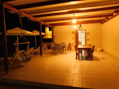 a room with a table and chairs and a dining room at Villa Leonton with a private pool in Kissamos