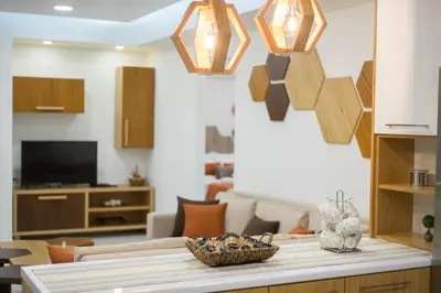 a living room with a table and some lights at Bee House in Kissamos