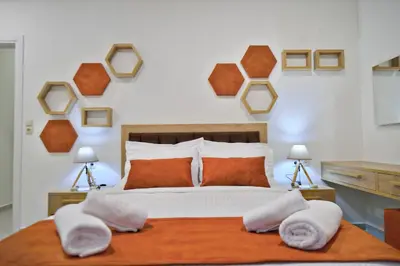 a bedroom with a bed with two pillows on it at Bee House in Kissamos