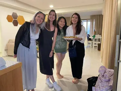 a group of women standing in a room with a plate of food at Bee House in Kissamos