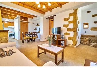 a living room with a couch and a table at Achilleas Apartments with Sea View in Kolymvari