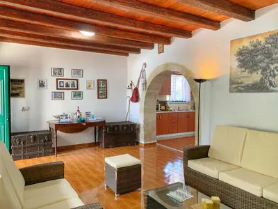 a living room with a couch and a table at Evaggelias Home Gavalochori in Gavalochori