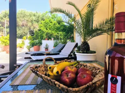 a basket of fruit on a table on a patio at Evaggelias Home Gavalochori in Gavalochori