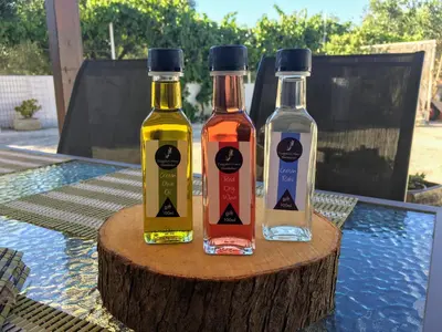 three bottles of alcohol sitting on top of a table at Evaggelias Home Gavalochori in Gavalochori