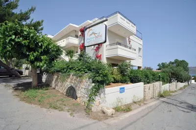 a building with a sign on the side of it at Merabello Apartments in Agia Marina Nea Kydonias