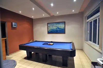 a billiard room with a blue pool table at Merabello Apartments in Agia Marina Nea Kydonias