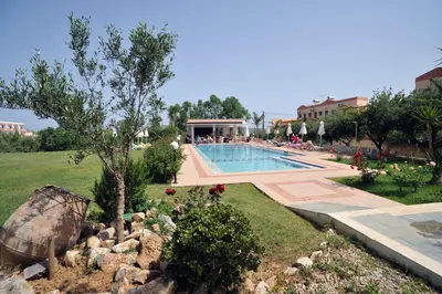 a resort with a swimming pool and a garden at Merabello Apartments in Agia Marina Nea Kydonias