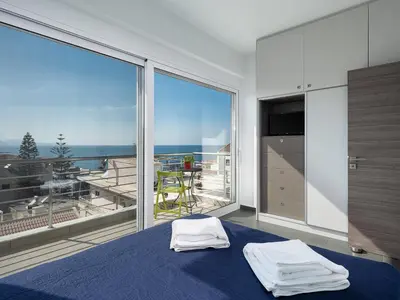 a bedroom with a bed and a large window at View Point Apartment in Chania Town