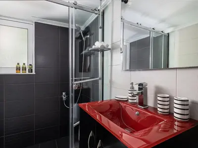a bathroom with a red sink and a shower at View Point Apartment in Chania Town