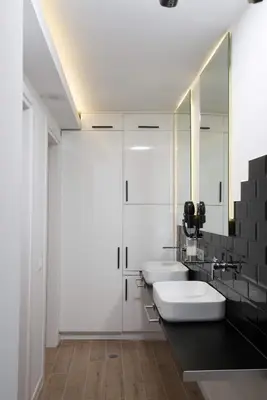 a bathroom with two sinks and two mirrors at Villa Sapphire in Almirida