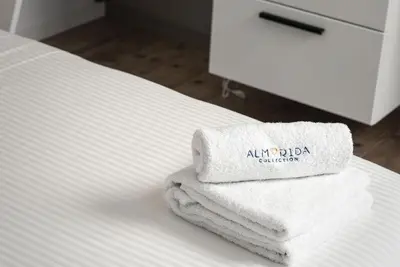 a pile of towels sitting on top of a bed at Villa Sapphire in Almirida