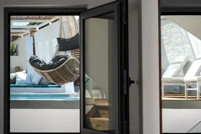 a glass door with a hammock in a house at Villa Sapphire in Almirida