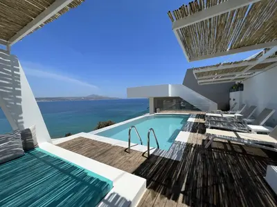 a house with a swimming pool with a view of the ocean at Villa Sapphire in Almirida