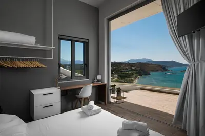 a bedroom with a bed and a large window with a view at Villa Sapphire in Almirida
