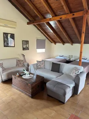 a living room with a couch and a table at Seafront Paradise steps to Beach in Plataniás
