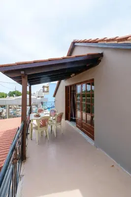 a patio with a table and chairs on a building at Seafront Paradise steps to Beach in Plataniás
