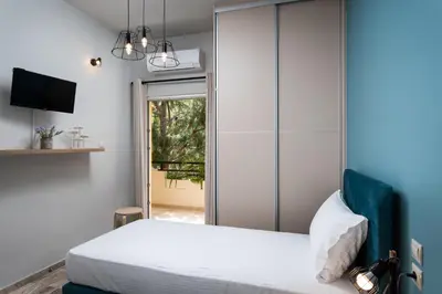 a bedroom with a bed and a sliding glass door at Dreamy Holidays Apartment in Chania Town