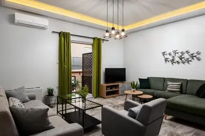 a living room with two couches and a tv at Dreamy Holidays Apartment in Chania Town