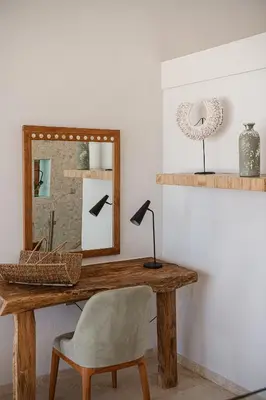 a desk with a mirror and a chair in a room at Villa Jamila by Cura Villas Collection in Kalathas