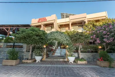 a building with trees and plants in front of it at Glaros Hotel in Palaiochóra