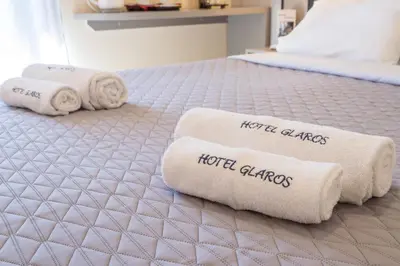 two towels on a bed with the words hotel dances at Glaros Hotel in Palaiochóra