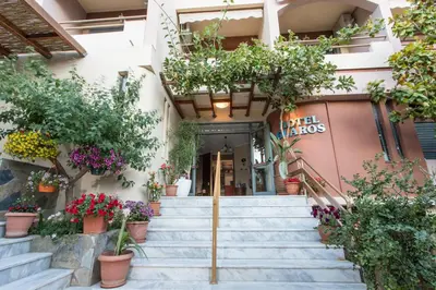 a building with potted plants on the stairs at Glaros Hotel in Palaiochóra