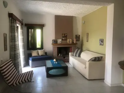 a living room with a couch and a table at Terpsichori villa and apartments in Kalamaki Chanion