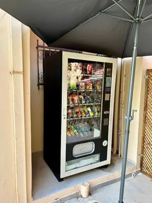 a vending machine is sitting on the side of a building at Terpsichori villa and apartments in Kalamaki Chanion